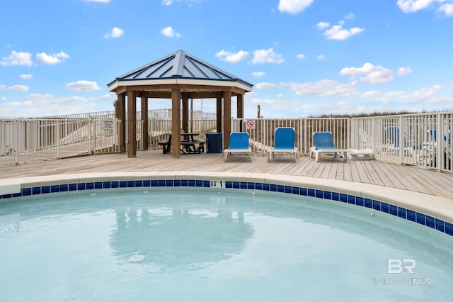 view of swimming pool with a wooden deck and a gazebo