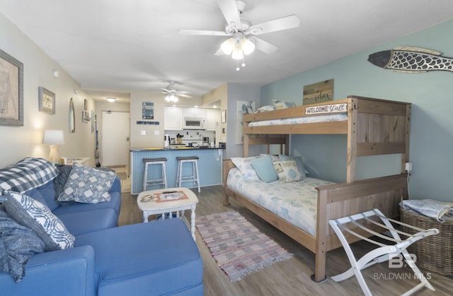 bedroom featuring ceiling fan and hardwood / wood-style flooring