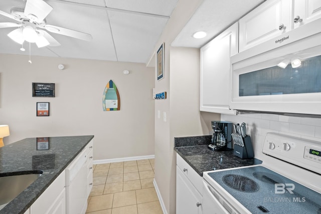 kitchen with ceiling fan, light tile patterned floors, white appliances, and white cabinets