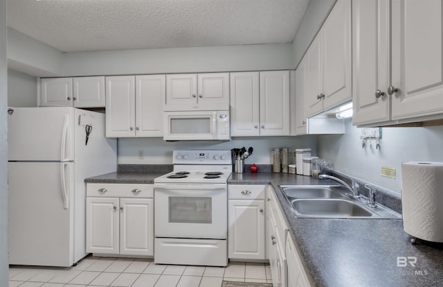 kitchen featuring white appliances, white cabinetry, and a sink