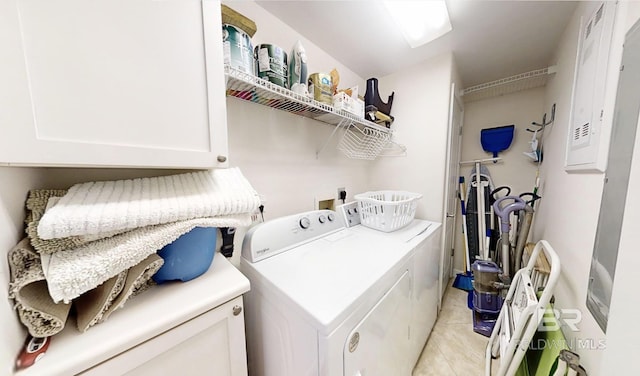 29235 Perdido Beach Blvd Unit 203, Orange Beach, AL 36561 - laundry area with washer and clothes dryer, light tile patterned floors, cabinet space, and electric panel
