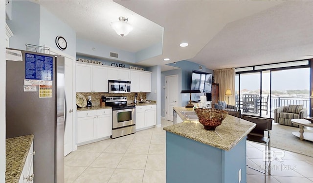 29235 Perdido Beach Blvd Unit 203, Orange Beach, AL 36561 - kitchen with appliances with stainless steel finishes, light tile patterned flooring, open floor plan, and recessed lighting