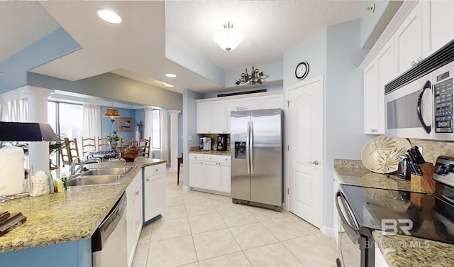 29235 Perdido Beach Blvd Unit 203, Orange Beach, AL 36561 - kitchen with appliances with stainless steel finishes, ornate columns, white cabinets, and recessed lighting