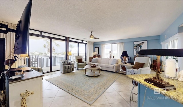 29235 Perdido Beach Blvd Unit 203, Orange Beach, AL 36561 - living area with ceiling fan, light tile patterned floors, and a textured ceiling