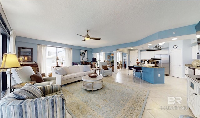 29235 Perdido Beach Blvd Unit 203, Orange Beach, AL 36561 - living area with a ceiling fan, a textured ceiling, and light tile patterned floors