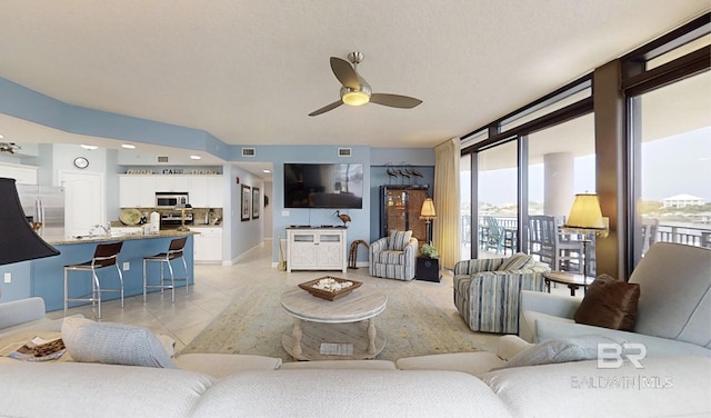 29235 Perdido Beach Blvd Unit 203, Orange Beach, AL 36561 - living area featuring ceiling fan, light tile patterned floors, and floor to ceiling windows