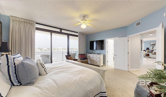 29235 Perdido Beach Blvd Unit 203, Orange Beach, AL 36561 - carpeted bedroom with access to outside, ceiling fan, and a textured ceiling