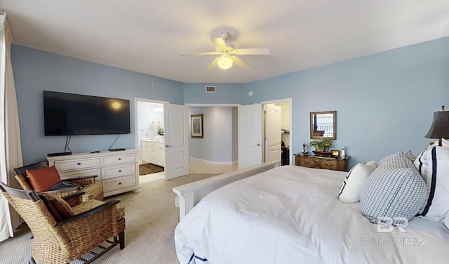29235 Perdido Beach Blvd Unit 203, Orange Beach, AL 36561 - bedroom with light carpet, ceiling fan, and ensuite bath