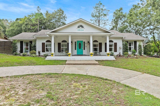 greek revival house with a front lawn and a porch