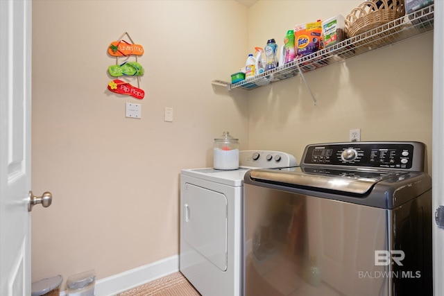 clothes washing area with washing machine and dryer