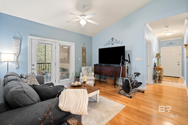 living room featuring hardwood / wood-style flooring, ceiling fan, crown molding, and vaulted ceiling