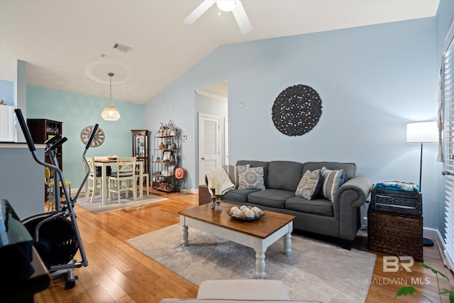 living room featuring light hardwood / wood-style flooring, ceiling fan, and lofted ceiling