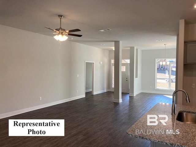 interior space featuring ceiling fan, sink, and dark hardwood / wood-style flooring