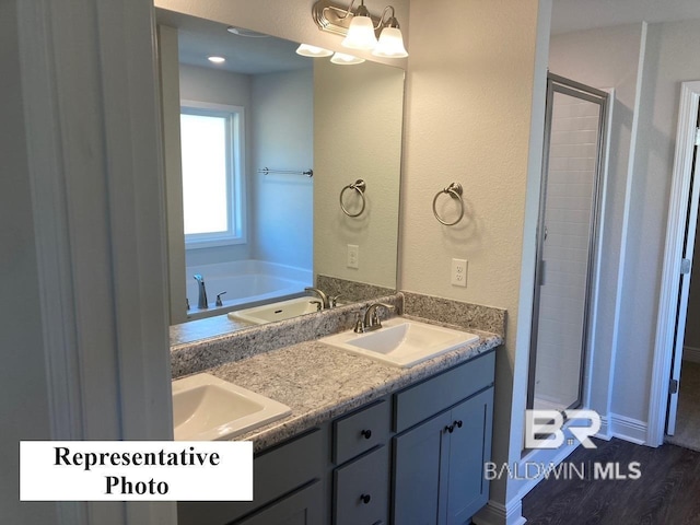 bathroom with vanity, plus walk in shower, and hardwood / wood-style flooring