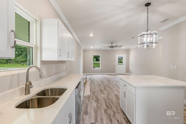 kitchen with white cabinetry, sink, and decorative light fixtures