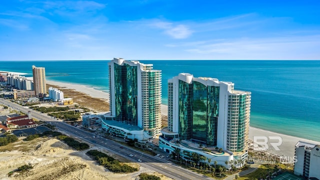 bird's eye view featuring a water view, a beach view, and a view of city