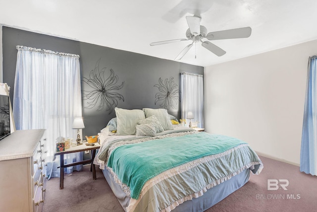 bedroom featuring ceiling fan and dark carpet