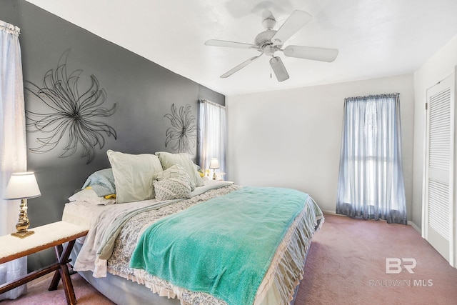 bedroom with ceiling fan, a closet, and carpet