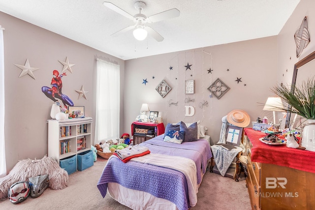 carpeted bedroom with ceiling fan and a textured ceiling