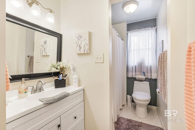 bathroom with tile patterned flooring, vanity, and toilet