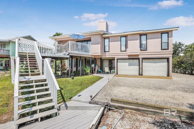 rear view of property featuring a yard and a garage