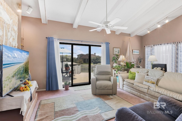 living room featuring vaulted ceiling with beams, light colored carpet, rail lighting, and ceiling fan