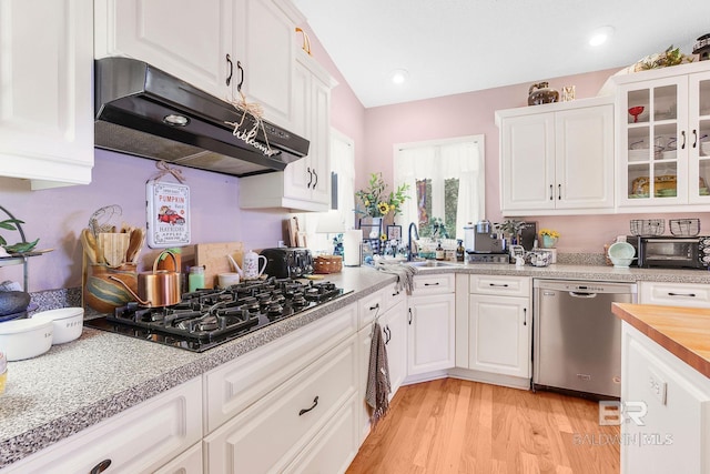 kitchen featuring light hardwood / wood-style flooring, dishwasher, black gas stovetop, and white cabinets