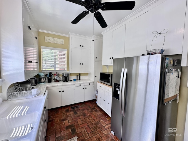 kitchen featuring stainless steel appliances, white cabinetry, ceiling fan, and crown molding