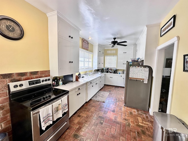 kitchen featuring ceiling fan, white cabinetry, and stainless steel appliances