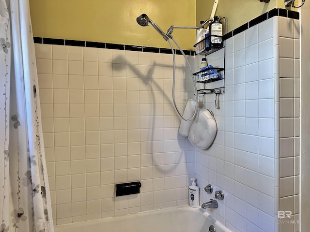 bathroom with shower / bath combo with shower curtain