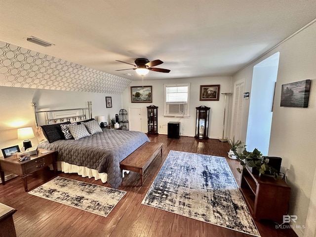 bedroom with ceiling fan and dark hardwood / wood-style floors