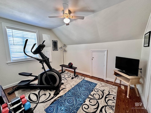 exercise room with ceiling fan, light hardwood / wood-style flooring, and vaulted ceiling