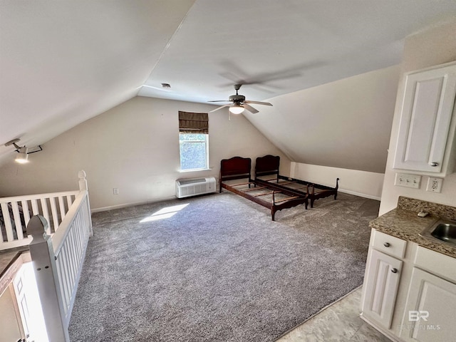 interior space featuring an AC wall unit, ceiling fan, sink, and vaulted ceiling