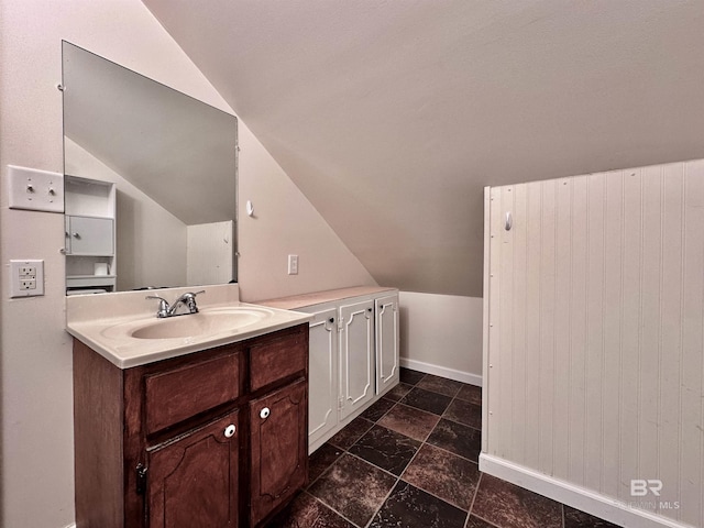 bathroom featuring vanity and lofted ceiling