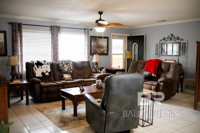 tiled living room with ceiling fan and ornamental molding