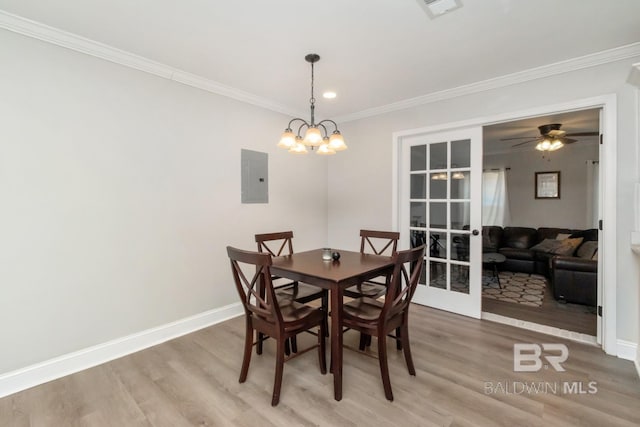 dining area with wood finished floors, baseboards, french doors, electric panel, and crown molding