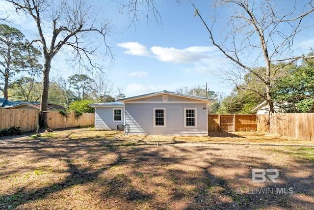 back of property featuring a fenced backyard