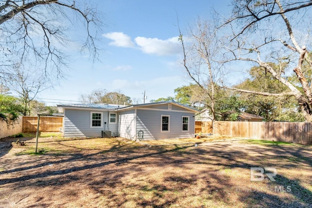 back of property with a fenced backyard