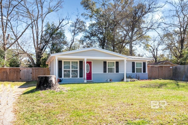 view of front of house with brick siding, fence, and a front lawn