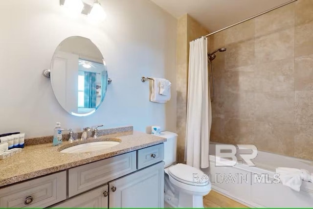 bathroom with shower / bath combination with curtain, vanity, and toilet