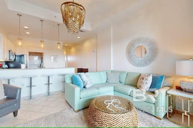 living room featuring light tile patterned floors, a chandelier, and recessed lighting