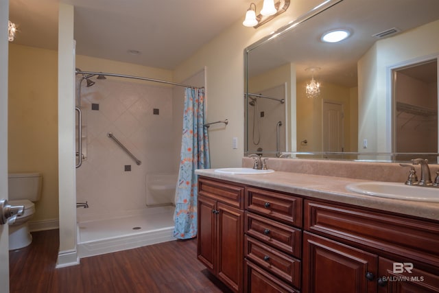 bathroom with hardwood / wood-style flooring, dual vanity, curtained shower, and toilet