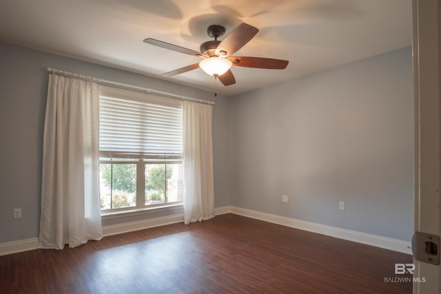 unfurnished room with ceiling fan and dark wood-type flooring