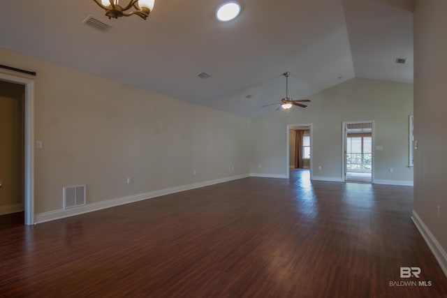 spare room with dark hardwood / wood-style floors, ceiling fan with notable chandelier, and lofted ceiling