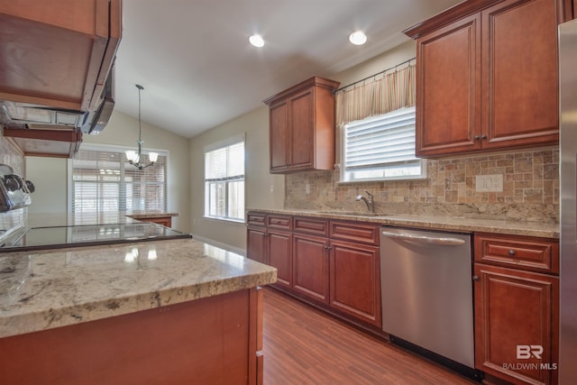 kitchen featuring dishwasher, light stone counters, hardwood / wood-style flooring, and pendant lighting