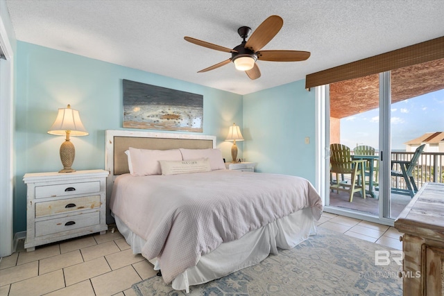 tiled bedroom featuring access to outside, a textured ceiling, and a ceiling fan