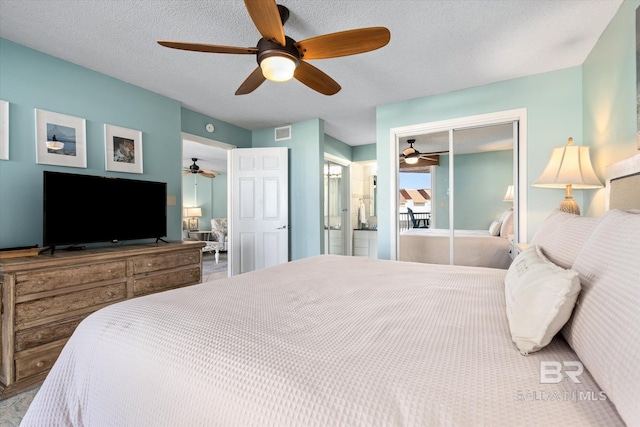 bedroom featuring a ceiling fan, a closet, and a textured ceiling