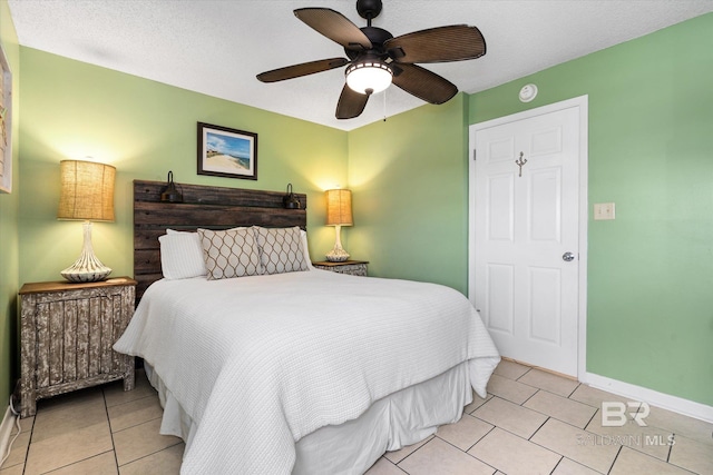 tiled bedroom featuring baseboards and ceiling fan