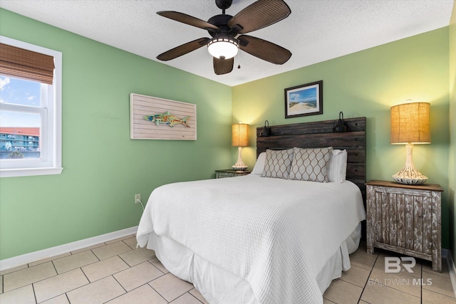 tiled bedroom featuring baseboards and ceiling fan