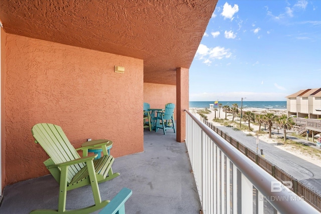 balcony with view of water and beach